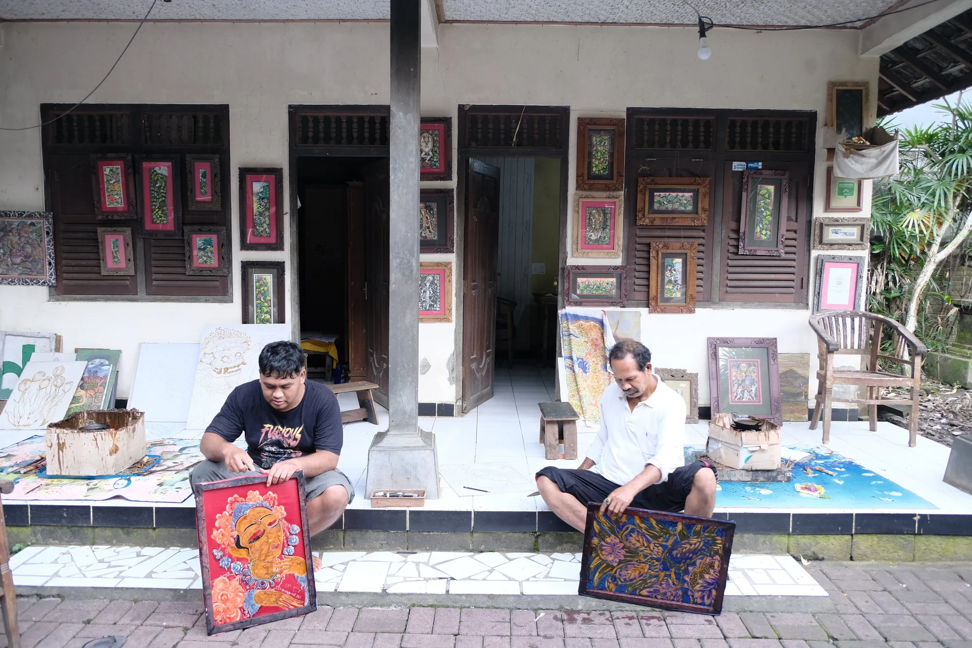 Drawing out the design with a chanting, Nyoman Warta and his son