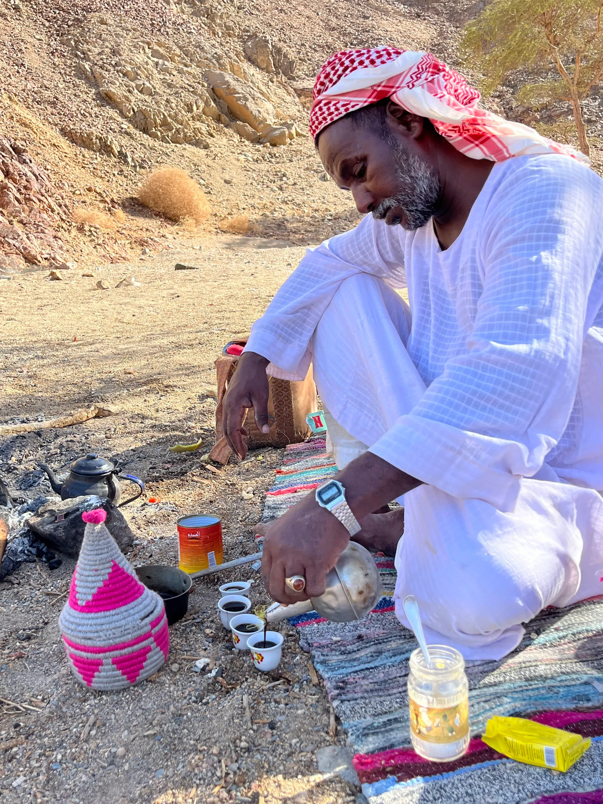 Bedouin meal, Moustafa pouring coffee from beans roasted over the fire, vegetarian stew made of beans, tomatoes, and onions