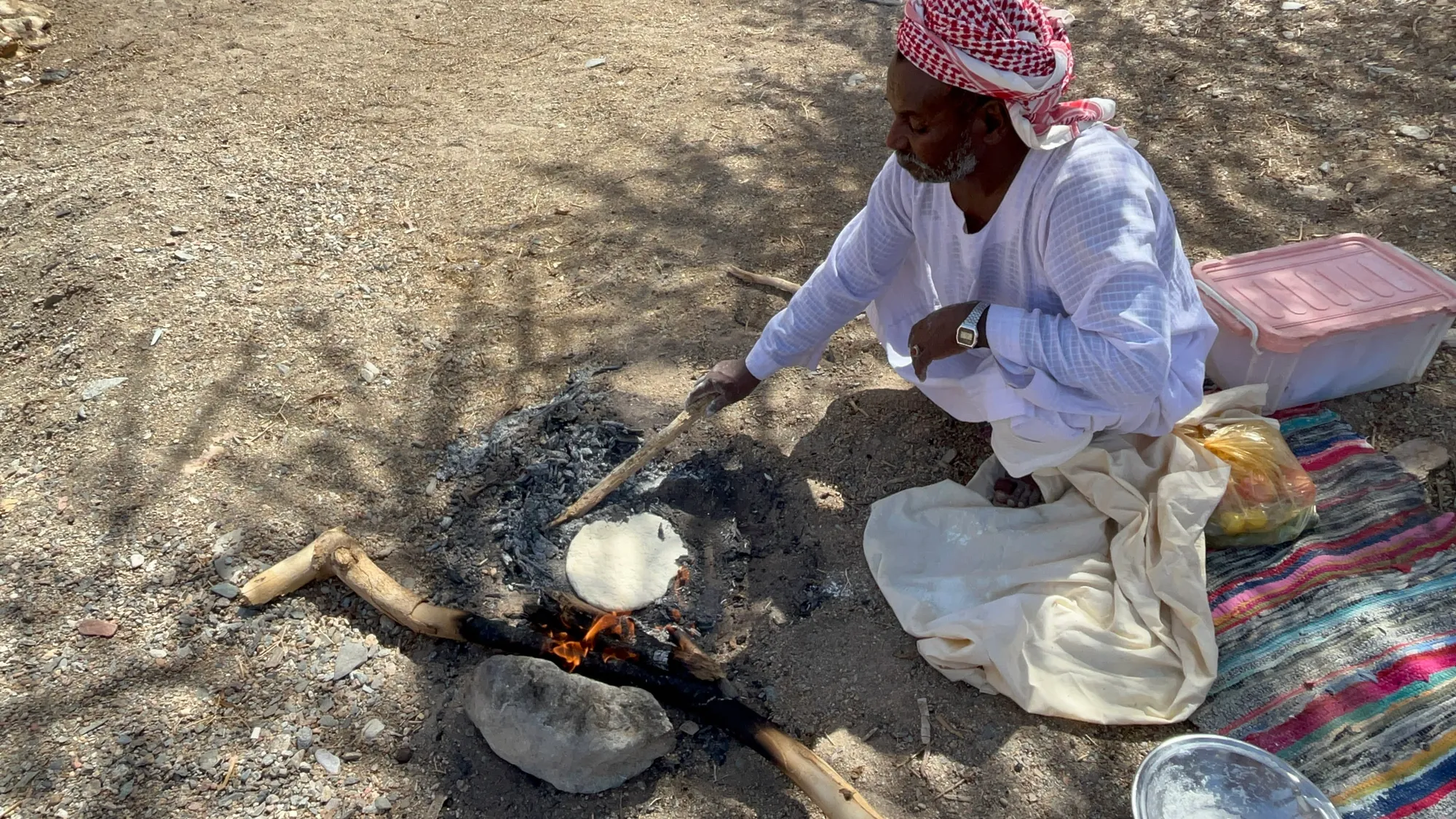 Moustafa making traditional Bedouin bread in the ashes