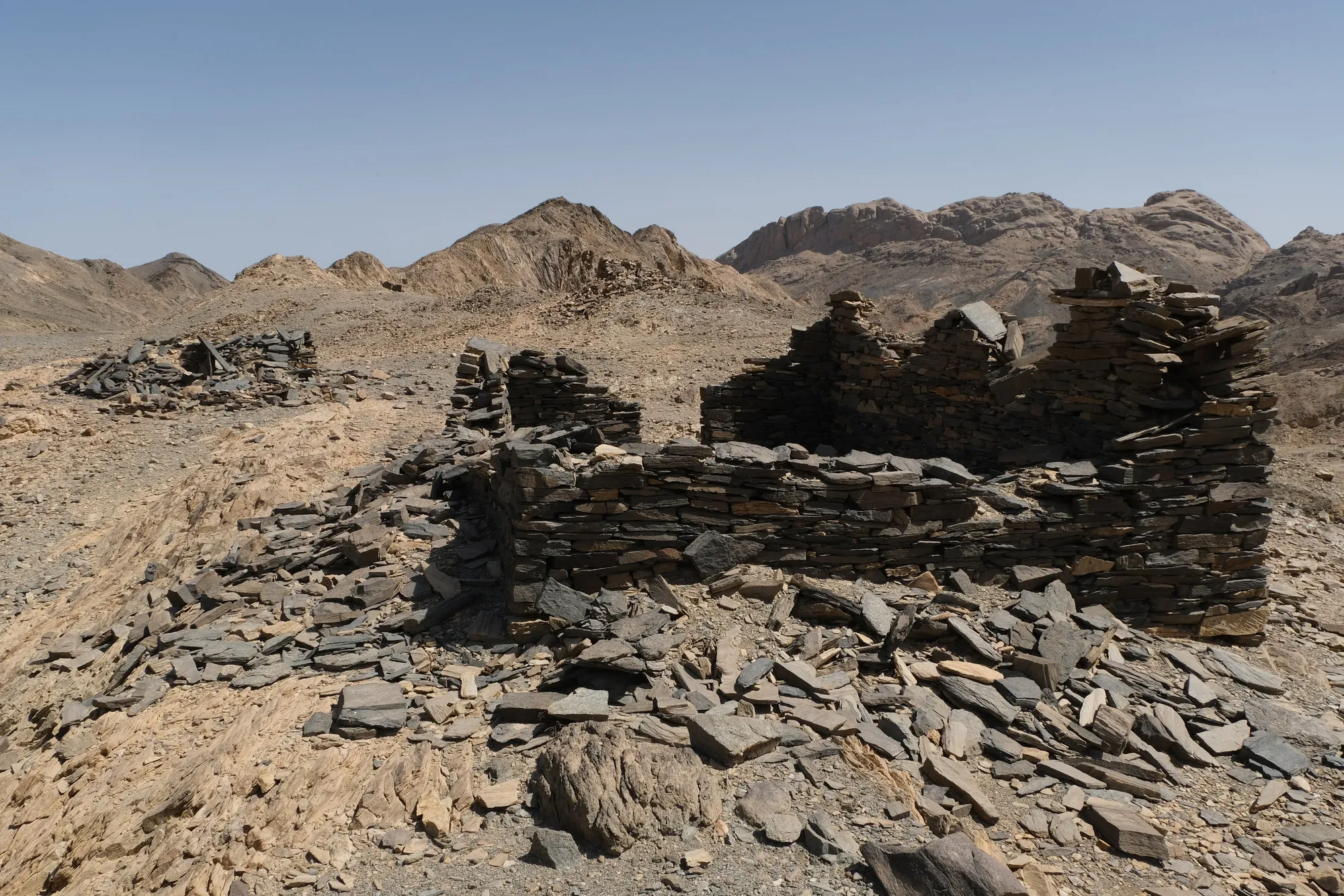 From left to right: Mustafa showing us emeralds he found on the wadi's floor, Sikait miners' living quarters and workshops