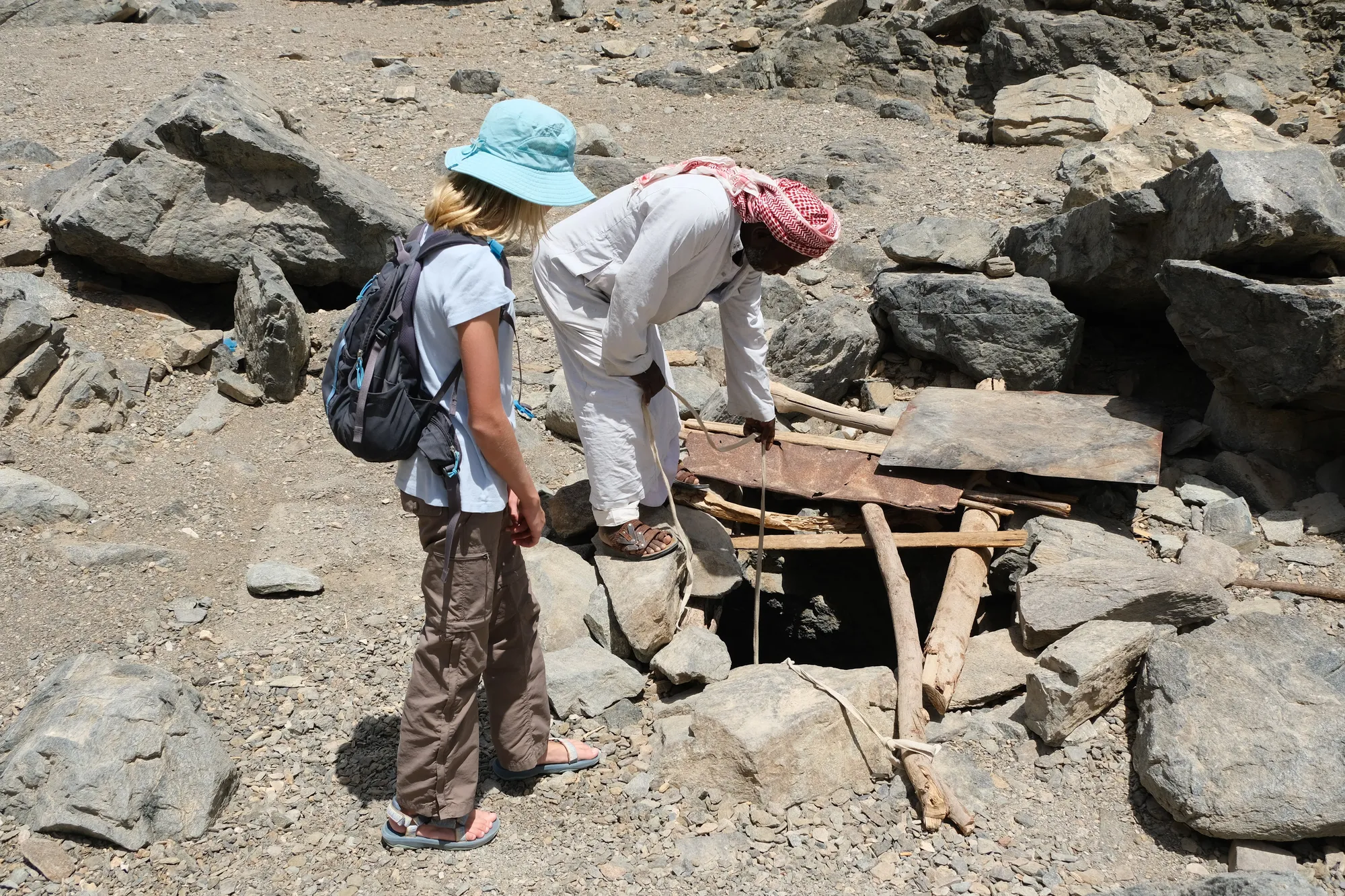 Moustafa demonstrating the water well and filling the reservoir for animals