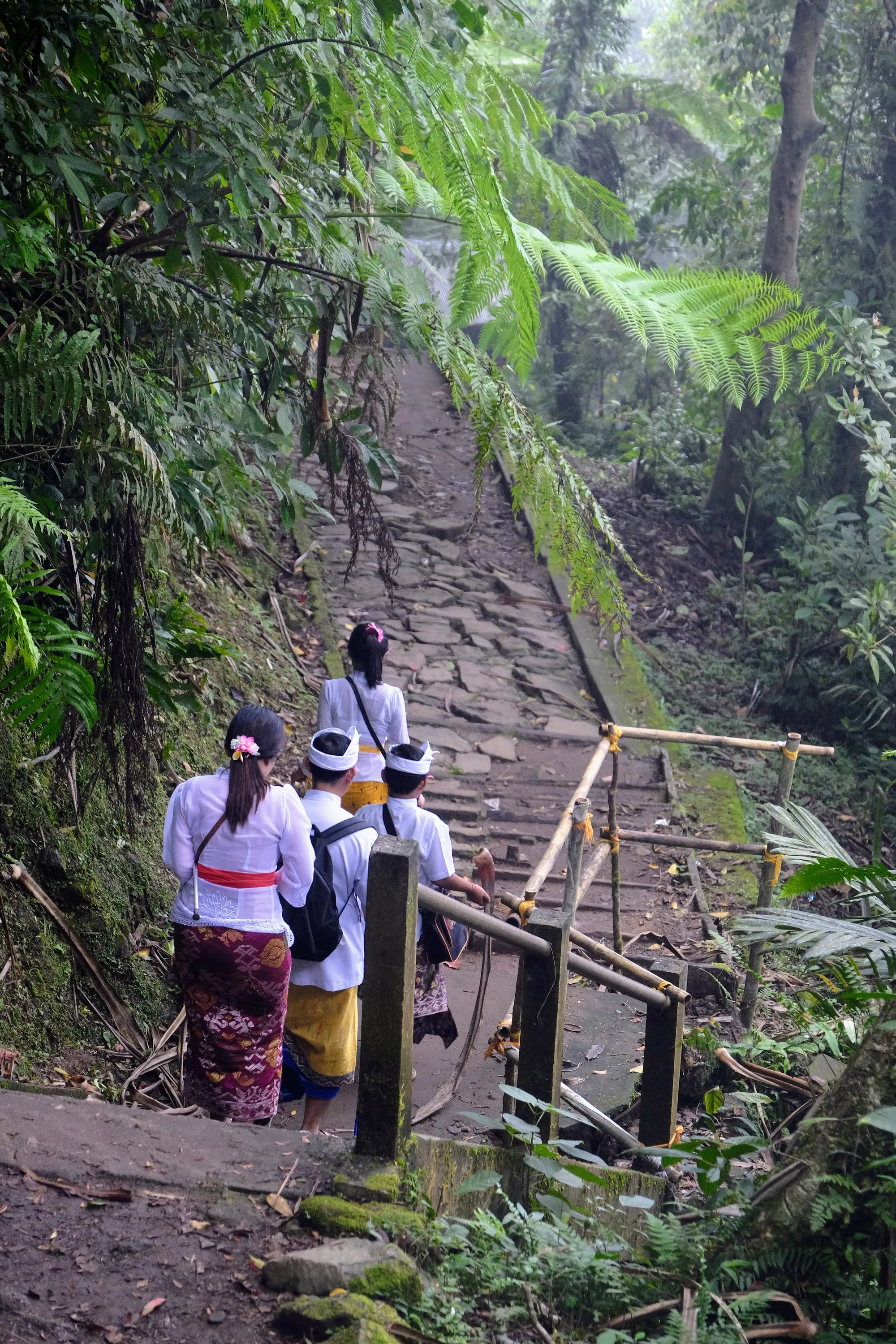 Climbing the stairs to the temples, local families who come to worship at the temple complex